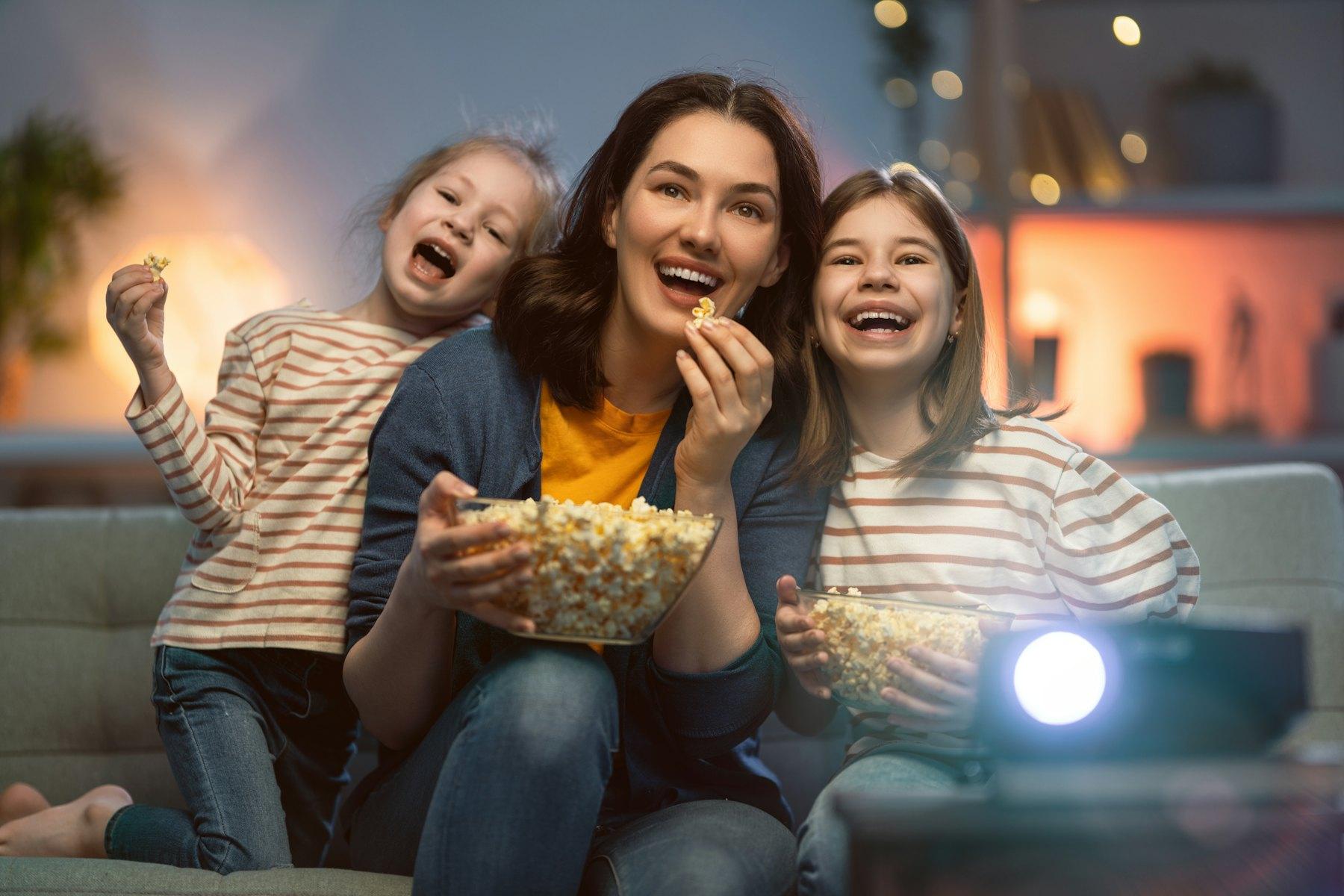 Mother and daughters enjoying movie night